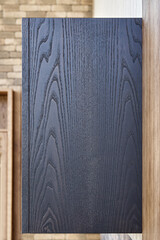 Wall Mural - Empty upper cabinet of black solid ash with dish dryer near stylish wainscoting made of thin planks in summer kitchen close side view