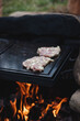 © Fauren - Preparation of pork neck pieces seasoned with basil, salt, olive oil, pepper, onion and garlic on a hot granite slab that receives heat from an open fire. The grilling season has begun