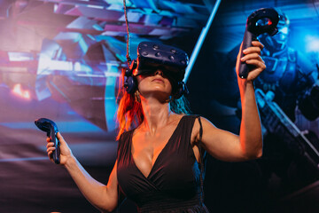 Virtual reality. A woman plays games in a virtual reality helmet.