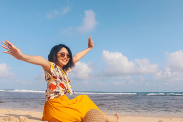 Portrait of happy smiling Asian woman on the beach wear hat