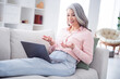 © deagreez - Portrait of attractive cheerful woman sitting on divan using laptop calling video conference meeting at home house indoor