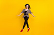 © deagreez - Full body photo of attractive young happy lady jump up smile good mood isolated on yellow color background