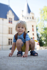 Poster - Child, toddler boy, playing on the premises of the Azay Le Rideau castle in Loire valley