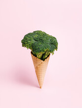 Fresh Broccoli In An Ice Cream Cone On Pastel Pink Background. Waffle Cone With A Vegetable As A Vegetarian Dessert. Creative Healthy Food Concept.