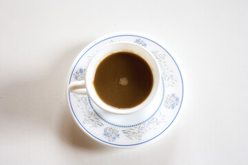 Poster - Top view of a cup of hot coffee on a white surface