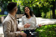 © JustLife - Happy funny couple with bicycle in the park. Loving couple enjoying together outdoors.