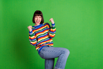 Canvas Print - Photo of happy young nice victorious young woman winner celebrate lucky lady isolated on green color background