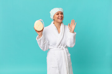 Wall Mural - young pretty woman smiling happily, waving hand, welcoming and greeting you and wearing bath robe after shower