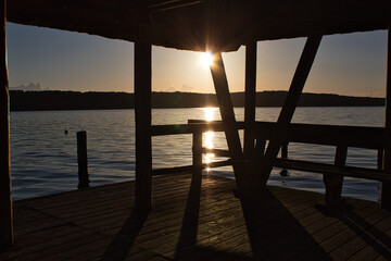 Wall Mural - Sunset at the lake on a boardwalk