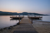 Fototapeta  - sunset over bay in Aegean sea. Torba, Bodrum, Turkey. October 2020. Long exposure picture with pier, jetty