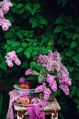 Wall Mural - Lavender glaze cake on a table in a spring garden..style vintage