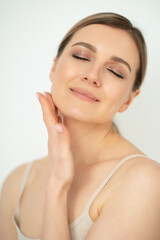 Beautiful calm middle aged woman, natural light. Anti-aging and beauty treatment.