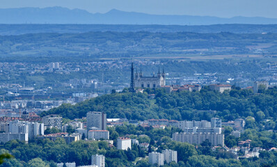 Panorama of the city of Lyon with as main subject the hill of Fourvière and its Basilica. In the background one sees the Alps.