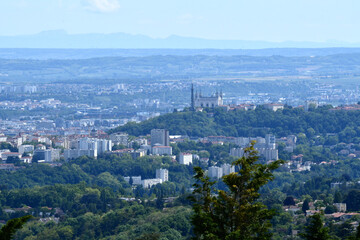 Panorama of the city of Lyon with as main subject the hill of Fourvière and its Basilica. In the background one sees the Alps.