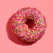Sprinkled delicious donut on pink background