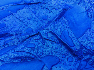 Droplets of rainwater on the blue tarp