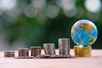 Poster - Saving money concept, stacking coins on green bokeh background, advertising coins of finance and banking