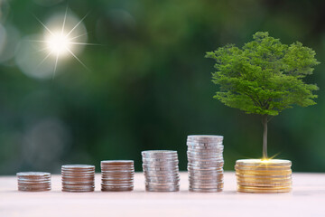 Canvas Print - saving money concept, stacking coins with globe on green bokeh background, Advertising coins of finance and banking, business growth concept