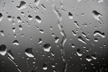 Image Of Water Droplets On A Clear Glass Surface During Heavy Rain.