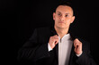 © blanke1973 - a young handsome man wears a black jacket and a white T-shirt on a black background