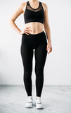 Premium Photo  Female sportswear active lifestyle workout apparel side view  of unrecognizable slim athletic woman body in black crop top bra leggings  on light background
