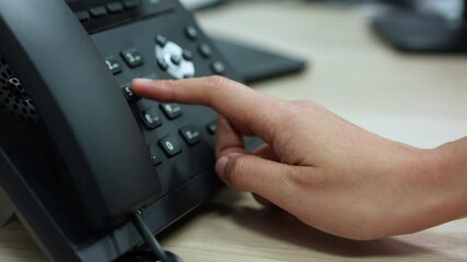 Wall Mural - slow motion scene of employee woman hand press number to dial and touching handset of telephone on desk for contact customer or receiving call for communication and helpdesk woking concept