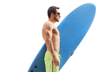 Wall Mural - Fit man with a surfboard standing and waiting