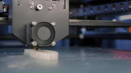 Automatic three dimensional printer machine printing flat plastic model at modern technology exhibition - close up. 3D printing, futuristic, equipment, prototype, manufacturing and production concept