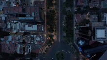 Aerial Birds Eye Overhead Top Down Panning View Of Traffic On Wide Street With Circular Crossroad. Flying Drone Following Road In Evening. Mexico City, Mexico.