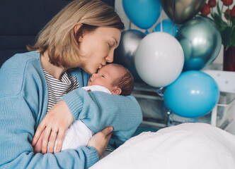 after baby delivery mother and baby at home. mother holds her newborn in hands. mom and baby togethe