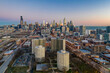 © AmazingAerialAgency - Aerial view of Chicago residential district near Park No. 540 with city skyline in background at sunset, Chicago, Illinois, United States.