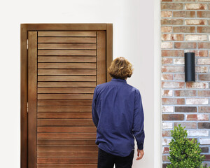 man opening the door .Inviting the guests.