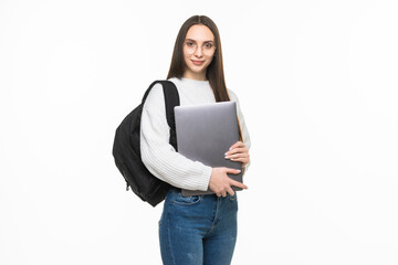 Happy cute student woman with backpack standing and holding laptop isolated on a white background