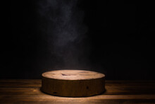 Empty Circular Wooden Cutiing Board With Smoke Float Up On Dark Background