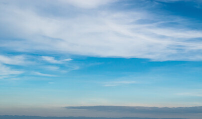 Wall Mural - Blue sky against soft white clouds. Beautiful natural cloudscape background.