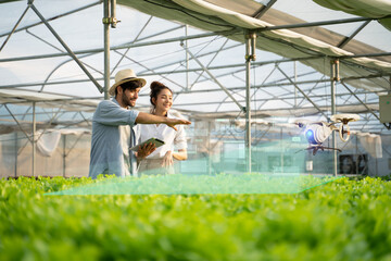 Wall Mural - 5g technology trend and smart farm agriculture concept.farmer use ai drone and robot farmers (automa
