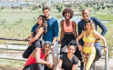 Wall Mural - Group portrait of runners smiling at camera.