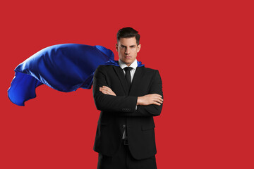 Wall Mural - Man wearing superhero cape on red background