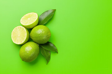Wall Mural - Fresh ripe citrus lime on green background