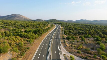 Wall Mural - aerial view on road. highway through mountain valley. view from a drone. natural landscape in summer