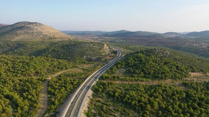 Wall Mural - aerial view on road. highway through mountain valley. view from a drone. natural landscape in summer