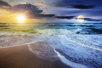Wall Mural - day and night time change concept above sea tide on a cloudy twilight. green waves crashing golden s