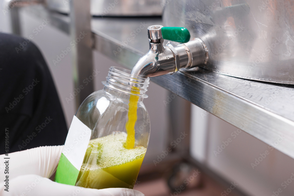 Close up photo of pouring fresh juice in bottle, JUICE INDUSTRY CONCEPT - obrazy, fototapety, plakaty 