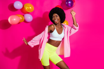 Sticker - Photo of charming funky dark skin woman dressed crop top dancing balloons looking empty space isolated pink color background