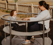 © mariokeeneye - Mother and daughter having fun with a spinning wheel at a children's playground