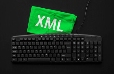 Extensible Markup Language. Rag width word XML and pc keyboard.
