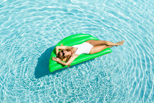 Attractive Cheerful Woman Floating On Air Mattress On Pool