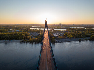 North bridge in Kiev. Rising sun rays along the bridge. Sunrise through the pylon. Aerial drone view.