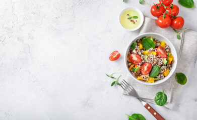 Wall Mural - Quinoa salad with tomatoes, batata and spinach on white backround. Vegan food concept. Top view. Copy space.