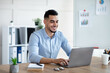 © Prostock-studio - Handsome young Arab businessman working with laptop computer at his desk in office